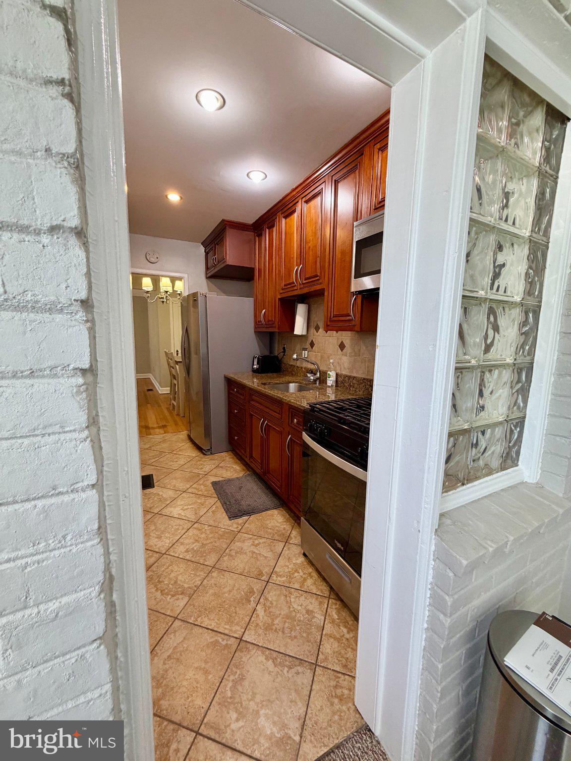 19 Hamilton Street Northeast, Unit 1 Washington, DC 20011 - Photo 11 of 17 Inviting kitchen with rich wood tones.