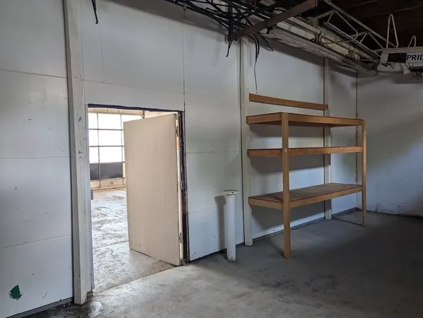 a view of an empty room with a cabinet