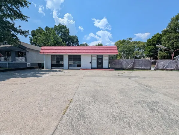 a front view of a house with a yard and a garage