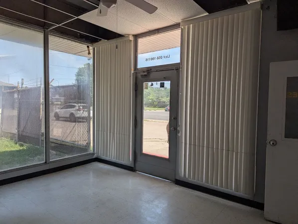 a view of a glass door with a yard