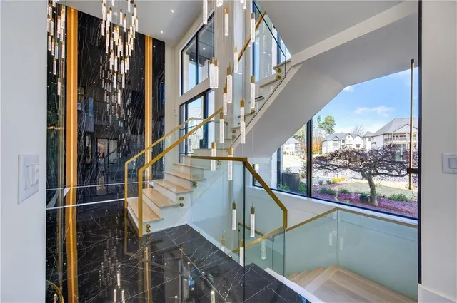 a living room with a large window and a wooden chair