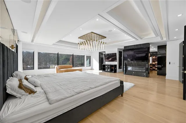 a spacious bedroom with a large bed and a large mirror