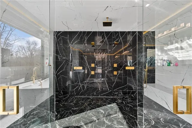 a bedroom with a bed and a large window