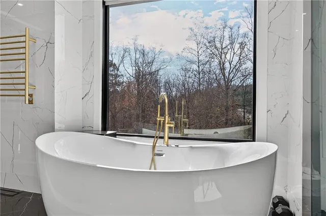a spacious bathroom with a double vanity sink a mirror and a shower