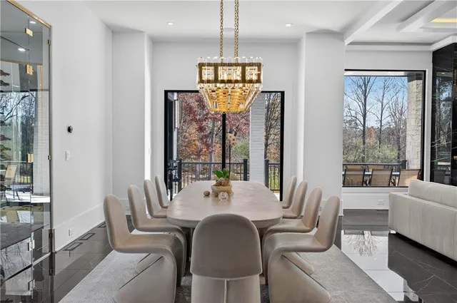 a living room with furniture a chandelier and a flat screen tv