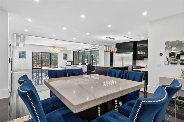 a view of a white building with swimming pool in front of it