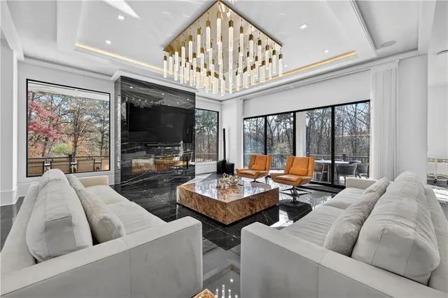 a living room with furniture and chandelier