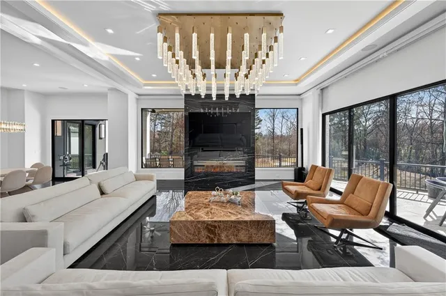a living room with furniture kitchen view and a flat screen tv