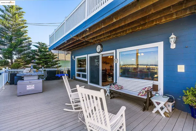 an aerial view of a city with lots of residential buildings and ocean view in back