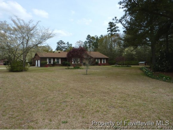 2588 Wade-Stedman Road Stedman, NC 28391 - Photo 1 of 25 a view of swimming pool with outdoor seating and covered with trees
