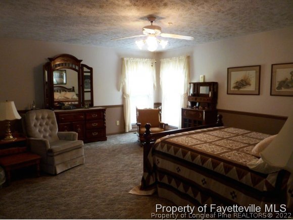 2588 Wade-Stedman Road Stedman, NC 28391 - Photo 23 of 25 a bedroom with a bed and furniture