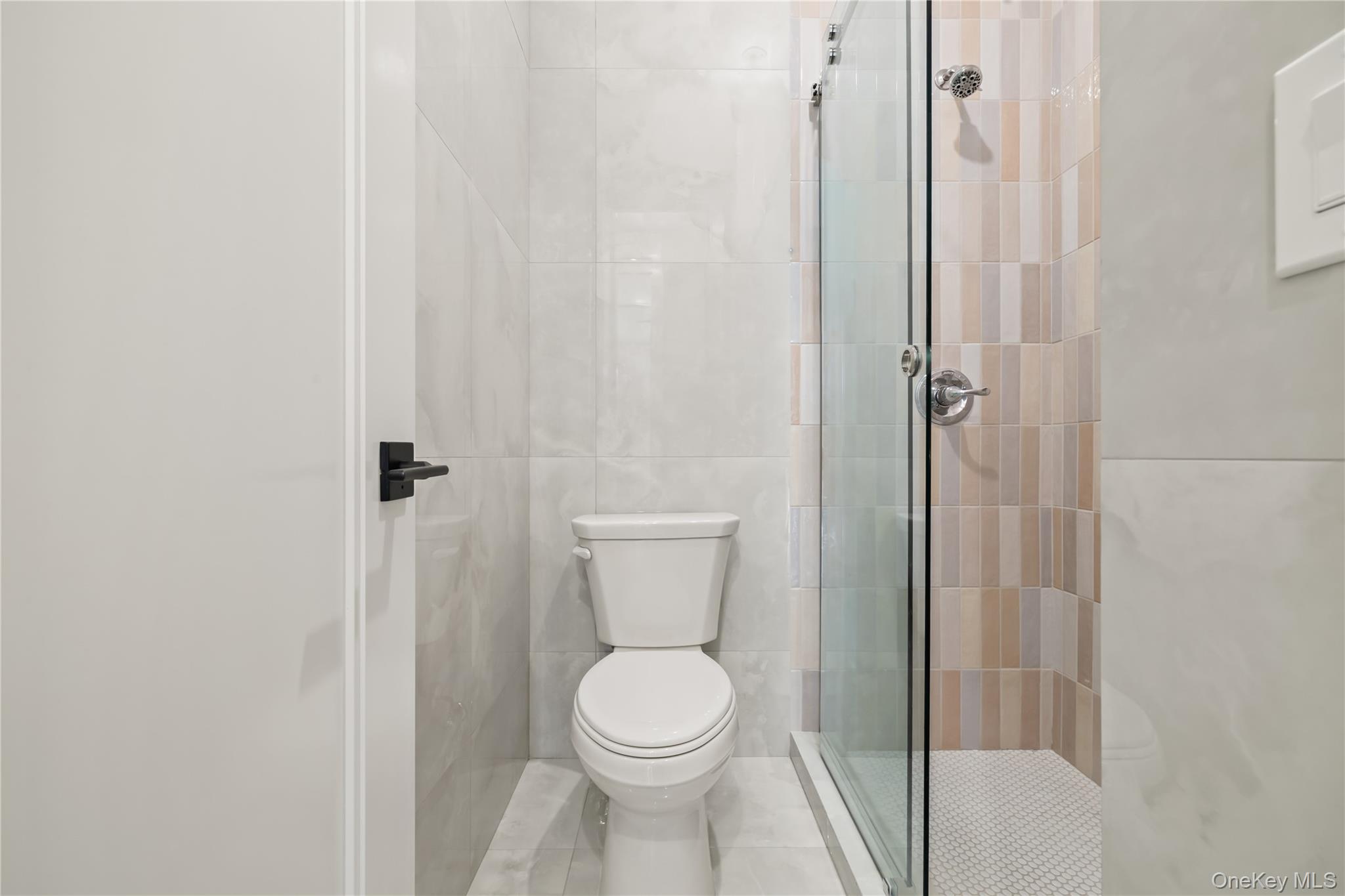 5 Mirror Lake Road, Unit 202 Spring Valley, NY 10977 - Photo 39 of 50 a white toilet sitting next to a bathroom sink