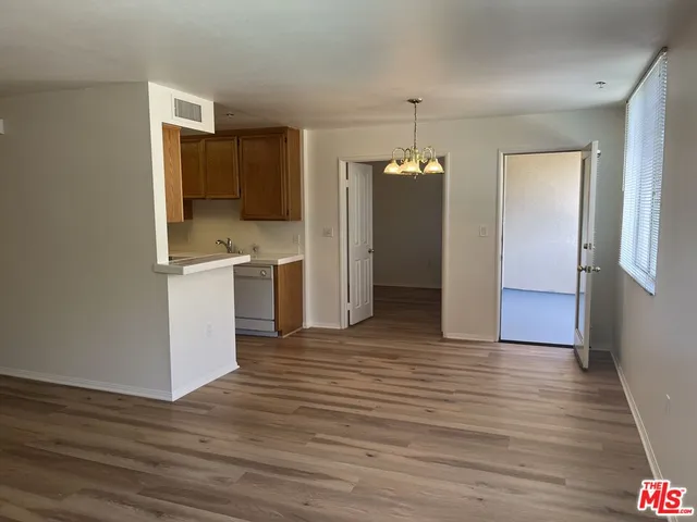 a view of a kitchen with wooden floor and a kitchen