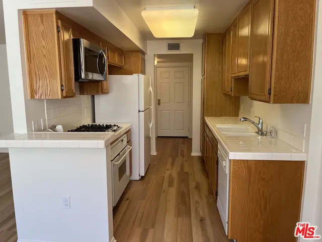 a kitchen with a sink stove and refrigerator