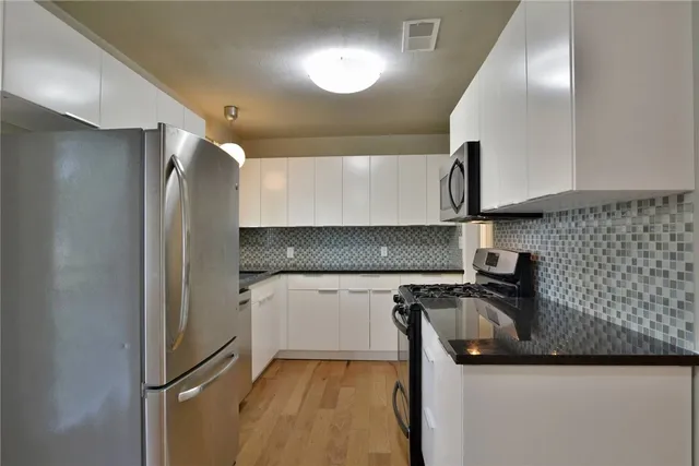 a kitchen with a sink and refrigerator