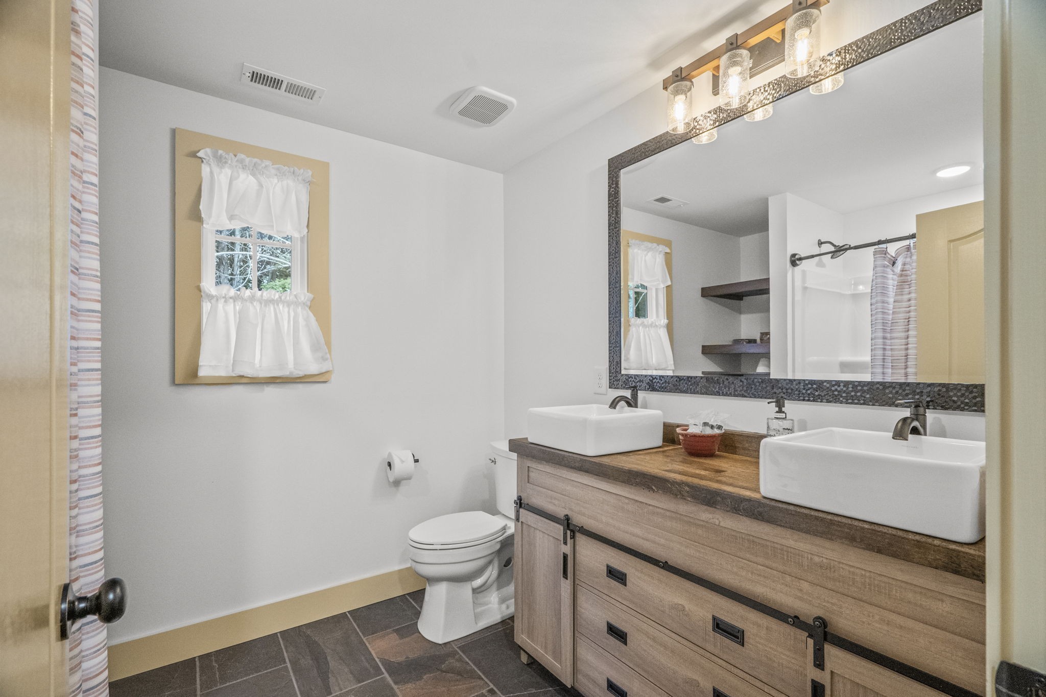 1068 Carl Perry Road Joelton, TN 37080 - Photo 32 of 58 a bathroom with a granite countertop sink mirror and toilet