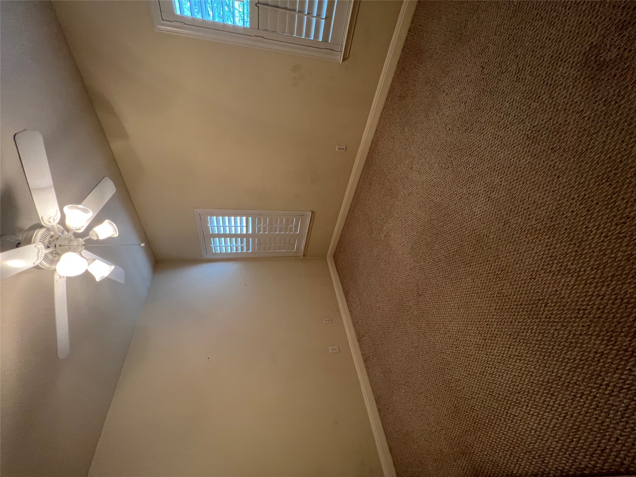 6126 Hartson Kyle, TX 78640 - Photo 13 of 14 an empty room with windows and fan chandelier