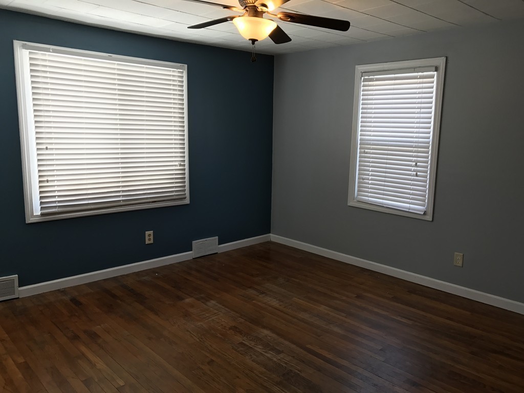 47 Healey Street Springfield, MA 01151 - Photo 7 of 22 a view of an empty room with wooden floor and a window