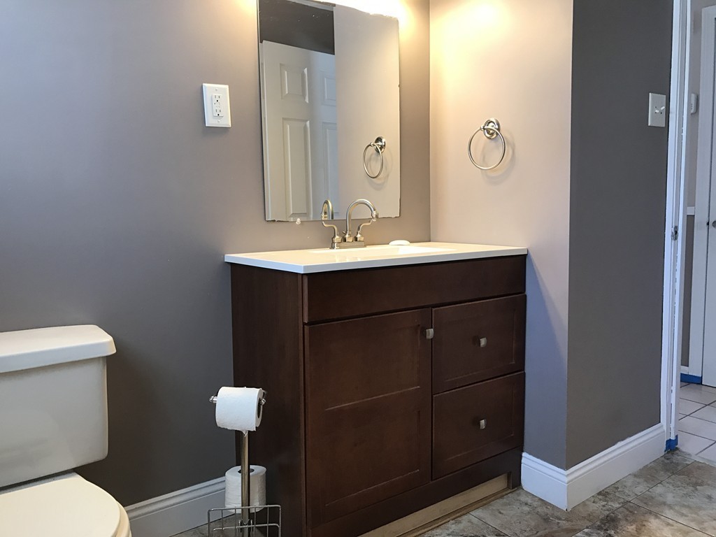 47 Healey Street Springfield, MA 01151 - Photo 8 of 22 a bathroom with a sink mirror and toilet