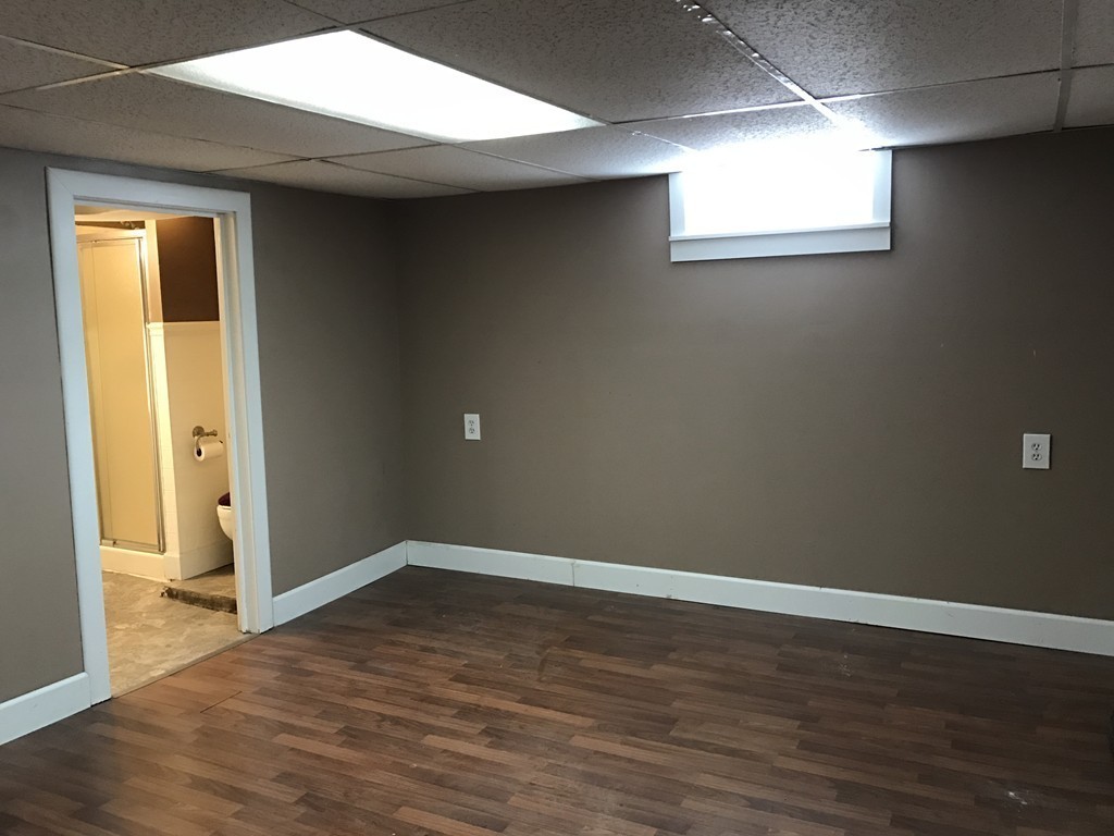 47 Healey Street Springfield, MA 01151 - Photo 10 of 22 an empty room with wooden floor and windows