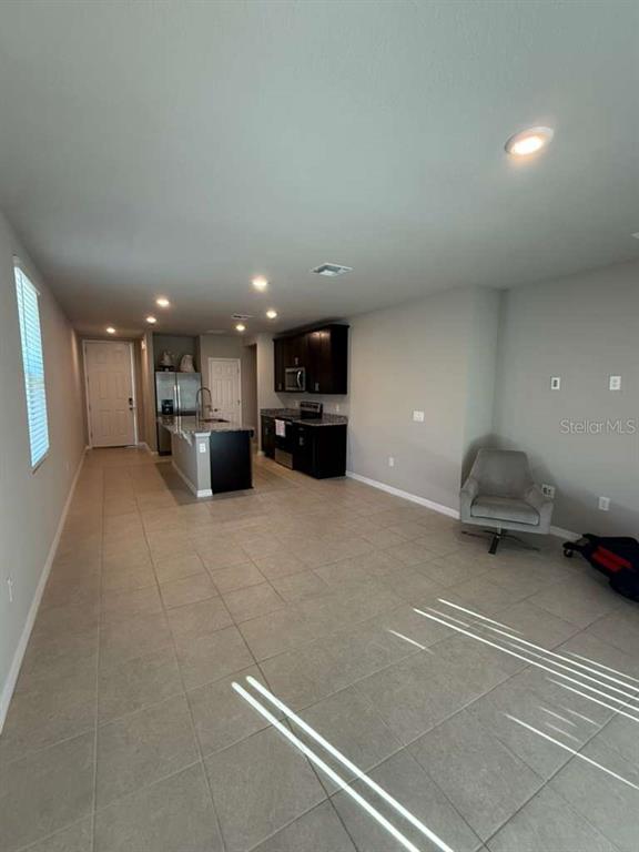 1788 Carnostie Road Winter Haven, FL 33884 - Photo 15 of 17 a swimming pool with a couch and a potted plant