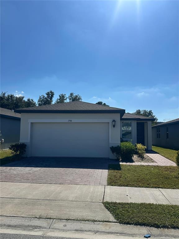 1788 Carnostie Road Winter Haven, FL 33884 - Photo 2 of 17 a view of a house with a yard