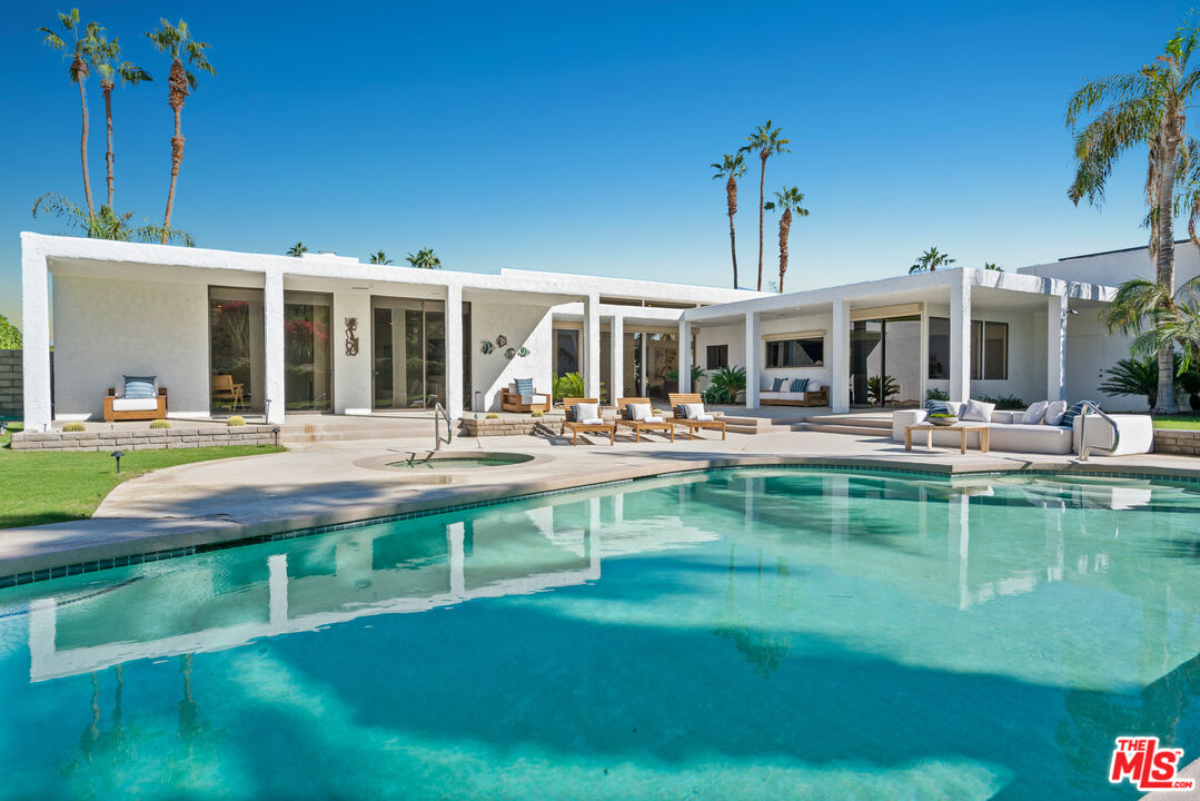 a view of a swimming pool with outdoor seating