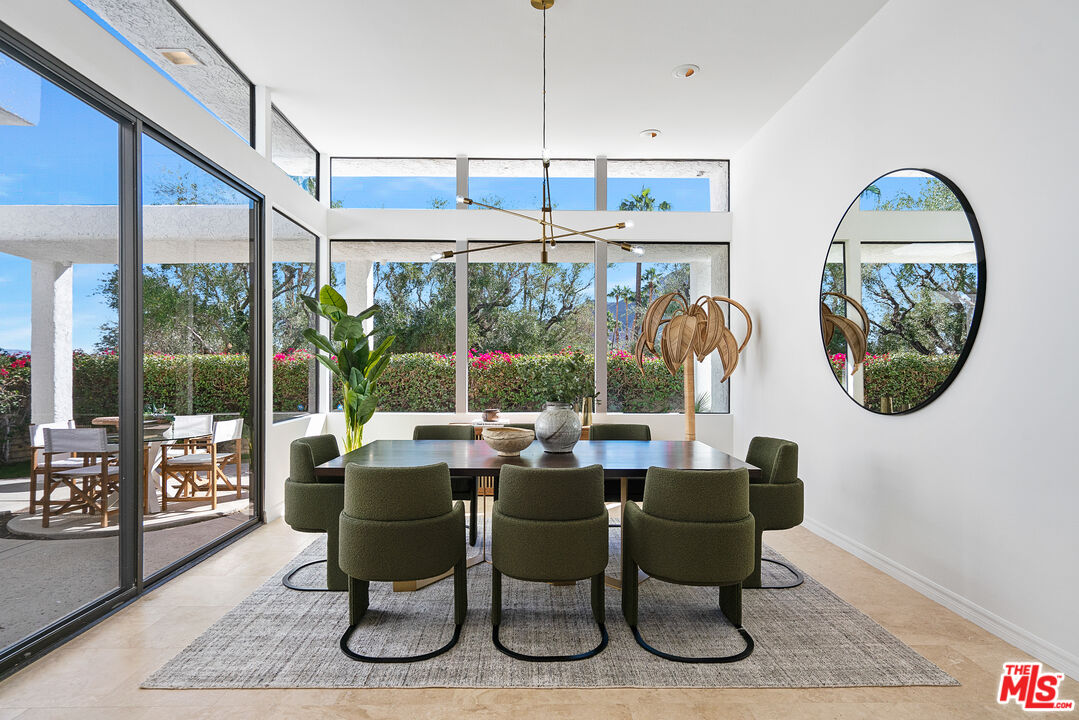 70551 Placerville Road Rancho Mirage, CA 92270 - Photo 12 of 42 a dining room with furniture a chandelier and wooden floor
