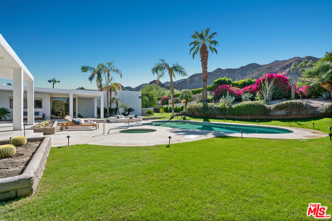 70551 Placerville Road Rancho Mirage, CA 92270 - Photo 17 of 42 a swimming pool with outdoor seating and yard