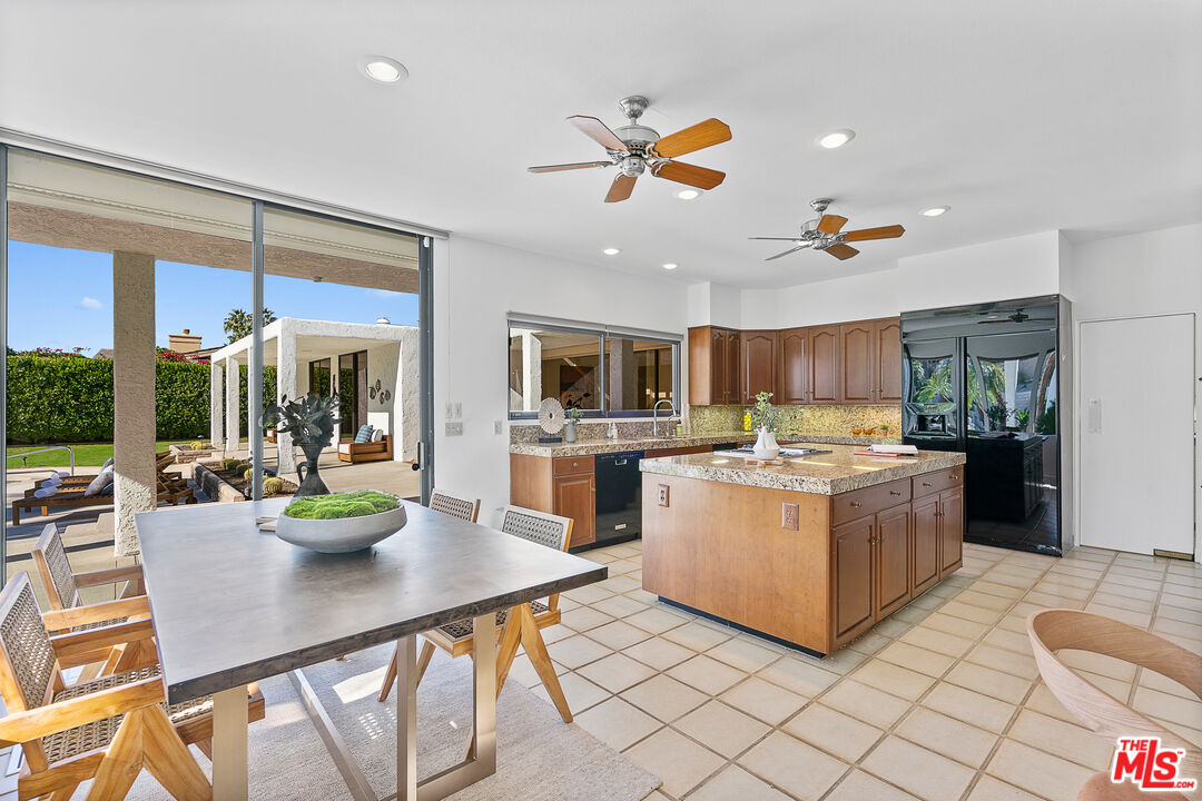 70551 Placerville Road Rancho Mirage, CA 92270 - Photo 26 of 42 a kitchen with stainless steel appliances granite countertop a stove and a refrigerator