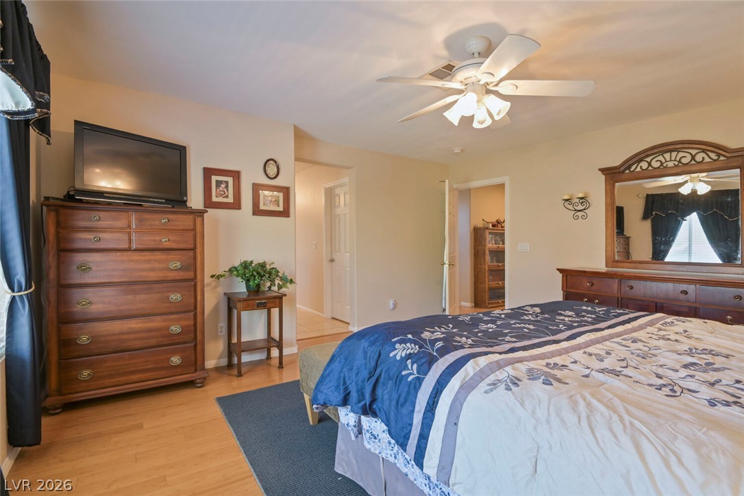 2356 Tilden Way Henderson, NV 89074 - Photo 17 of 30 Hardwood flooring extends throughout this naturally illuminated primary bedroom, offering comfort and refined style.