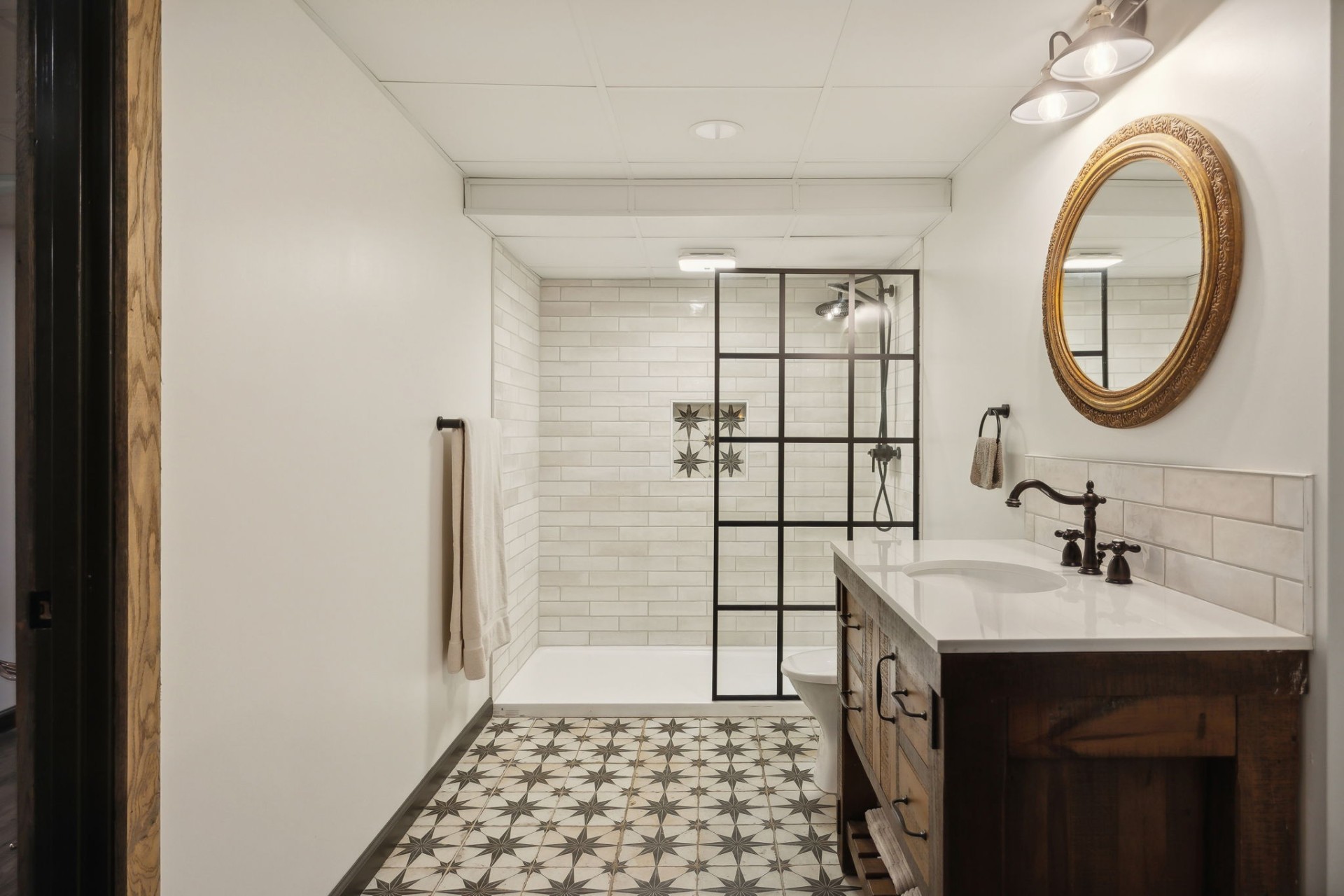 5617 A Pinewood Road Franklin, TN 37064 - Photo 52 of 67 a bathroom with a sink a mirror and a shower
