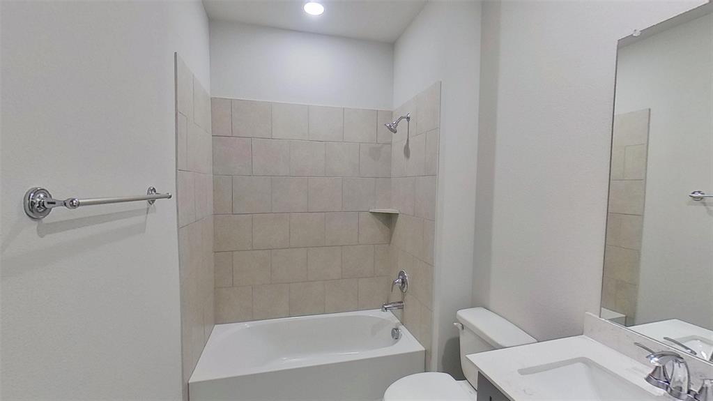 415 Magellan Road Seagoville, TX 75159 - Photo 9 of 12 a bathroom with a bathtub and shower