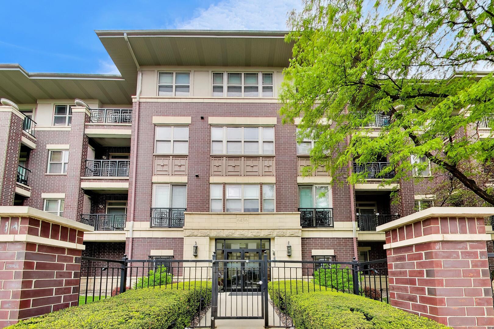 6436 Roosevelt Road, Unit 212 Oak Park, IL 60304 - Photo 1 of 22 a front view of a building with a garden
