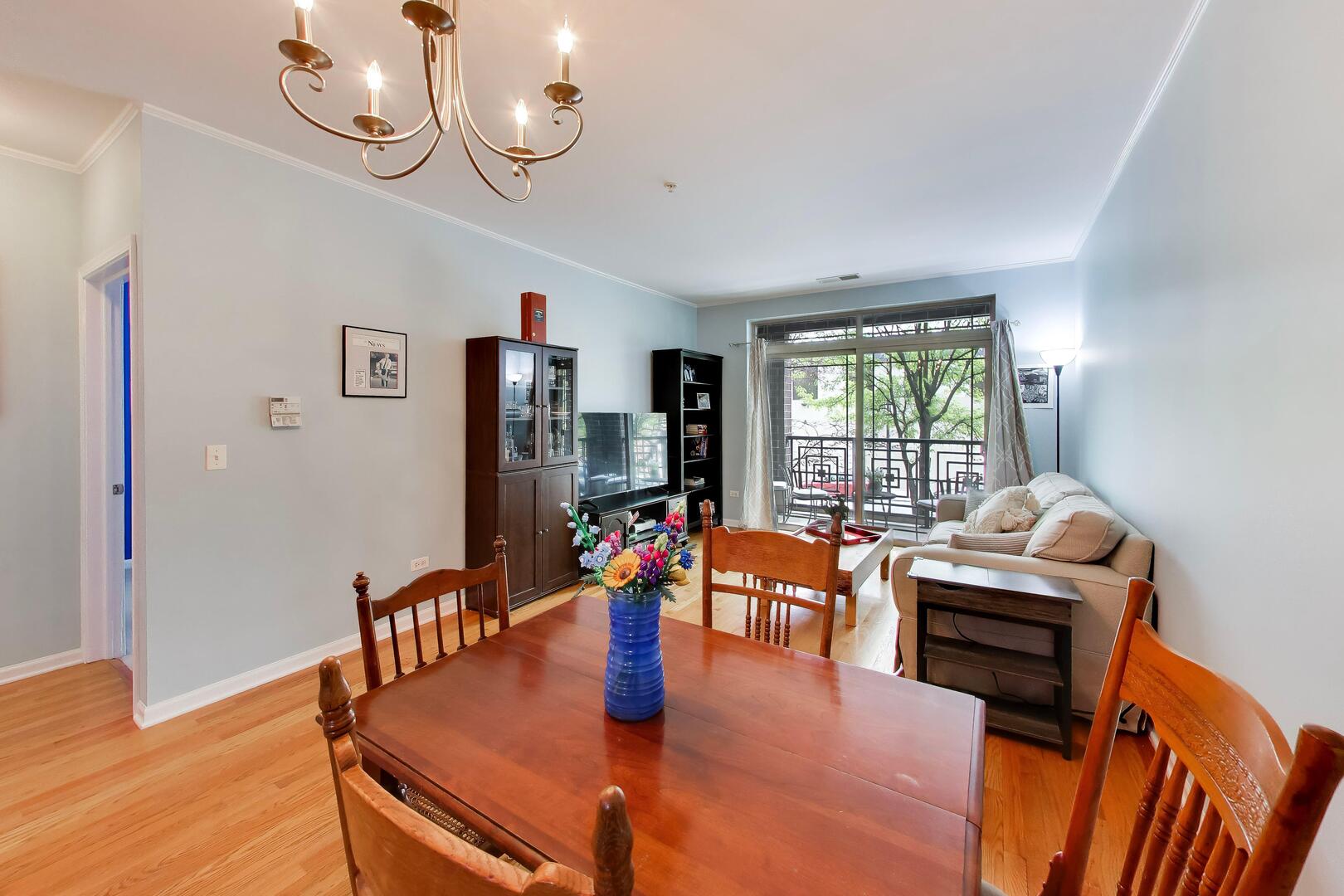 6436 Roosevelt Road, Unit 212 Oak Park, IL 60304 - Photo 9 of 22 a view of a dining room with furniture window and wooden floor