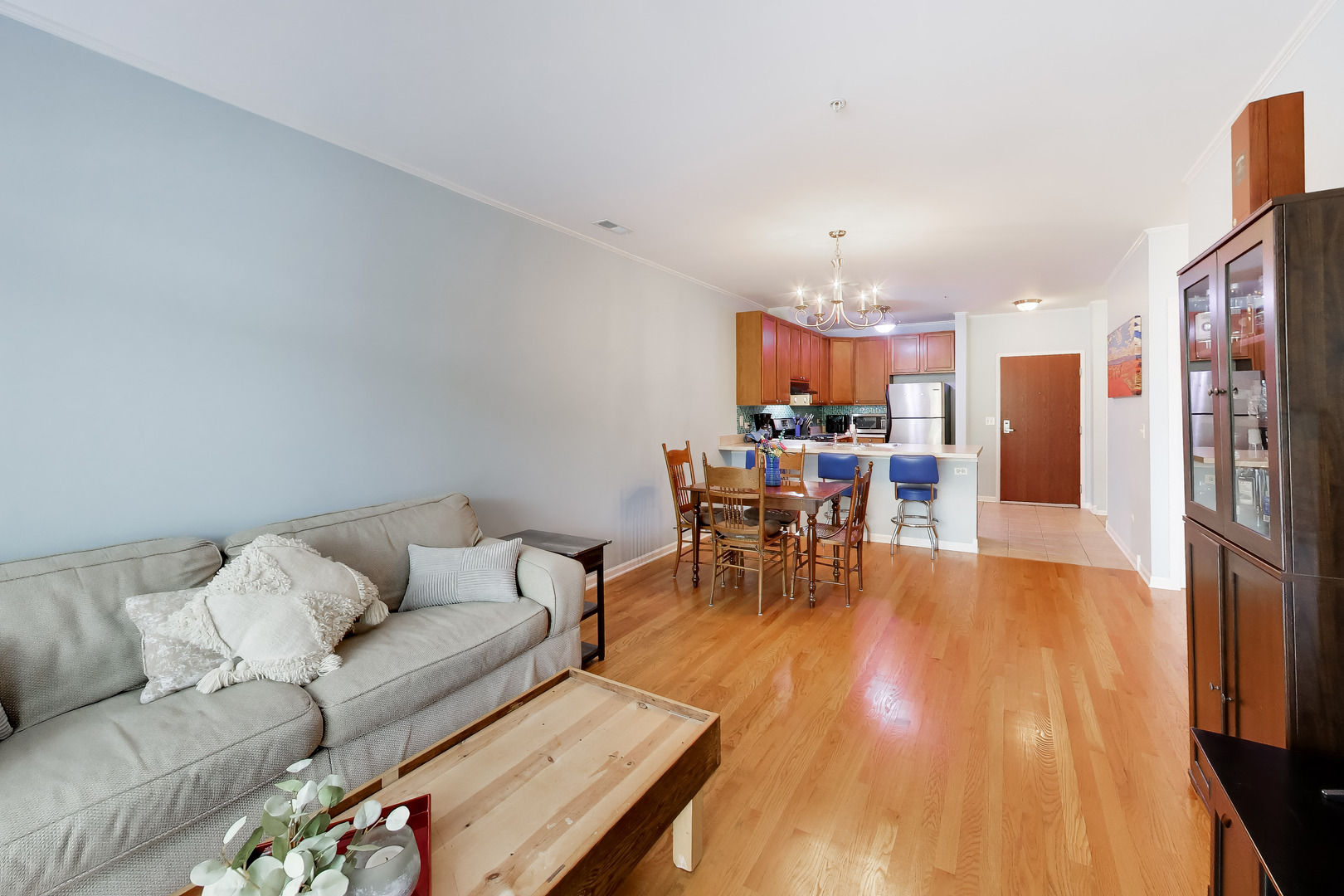 6436 Roosevelt Road, Unit 212 Oak Park, IL 60304 - Photo 10 of 22 a living room with furniture and a dining table with wooden floor