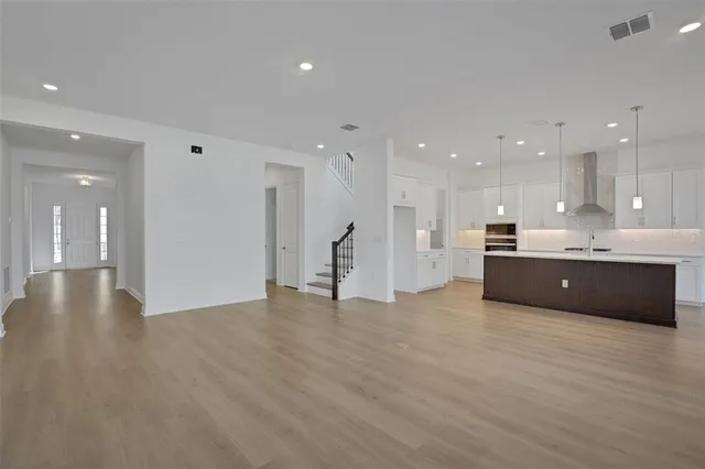 a view of kitchen with kitchen island stainless steel appliances sink and cabinets
