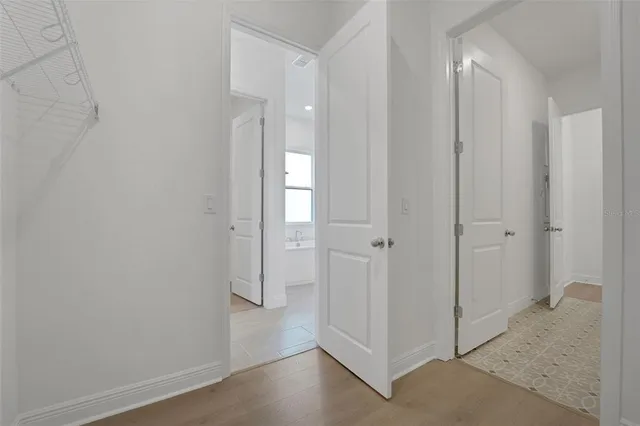 a view of a hallway with wooden floor