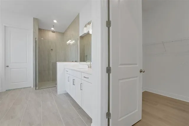 a bathroom with a double vanity sink a toilet and a shower