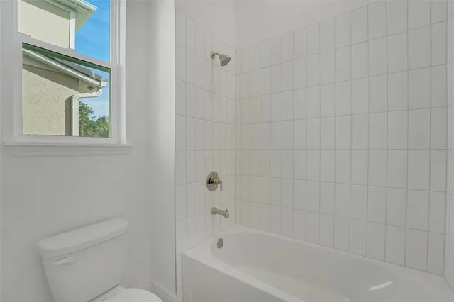 a bathroom with a sink a light fixture and a mirror