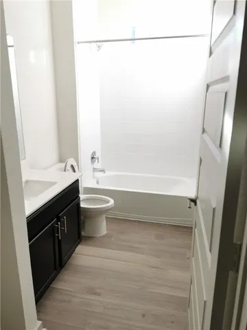 a bathroom with a double vanity sink toilet and shower