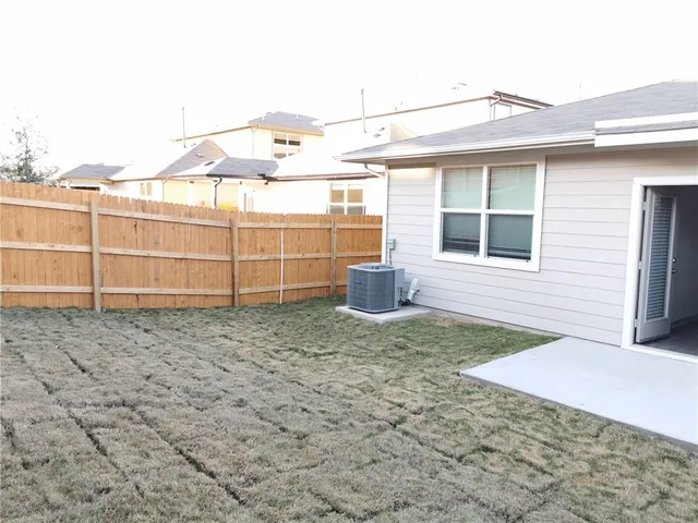 a view of a backyard with pathway