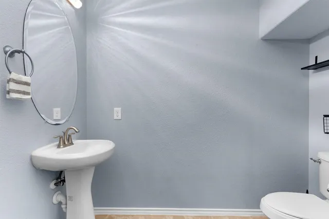 a bathroom with a sink toilet