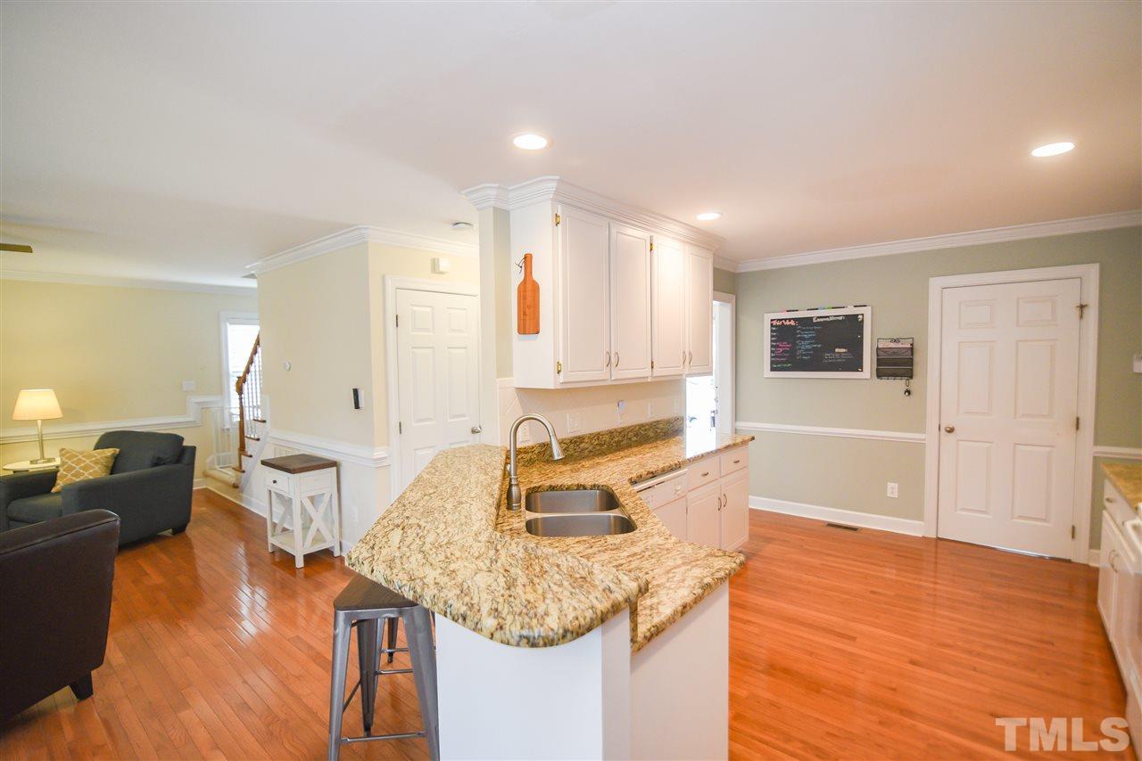 9200 Dawnshire Road Raleigh, NC 27615 - Photo 11 of 30 a kitchen with stainless steel appliances granite countertop a sink and cabinets