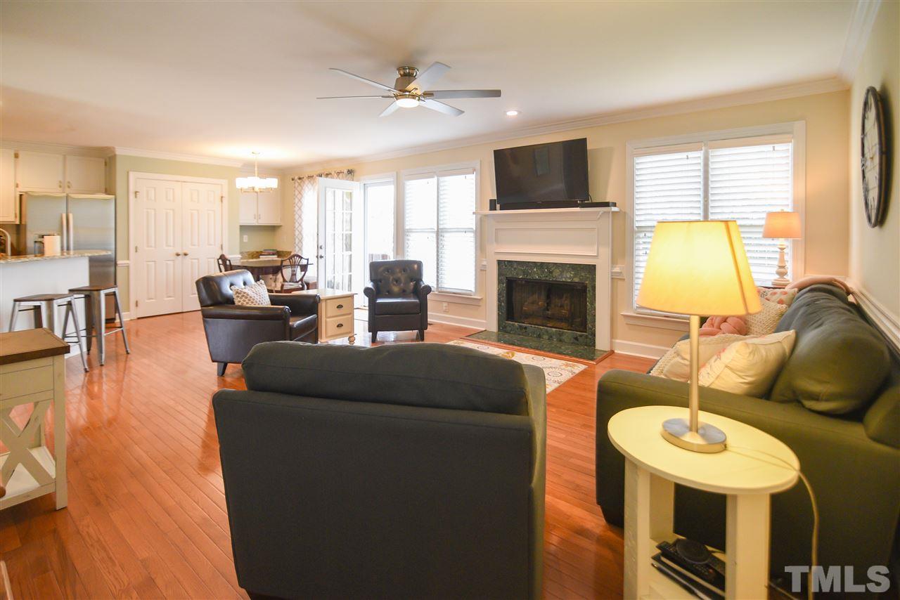 9200 Dawnshire Road Raleigh, NC 27615 - Photo 15 of 30 a living room with furniture a fireplace and a flat screen tv