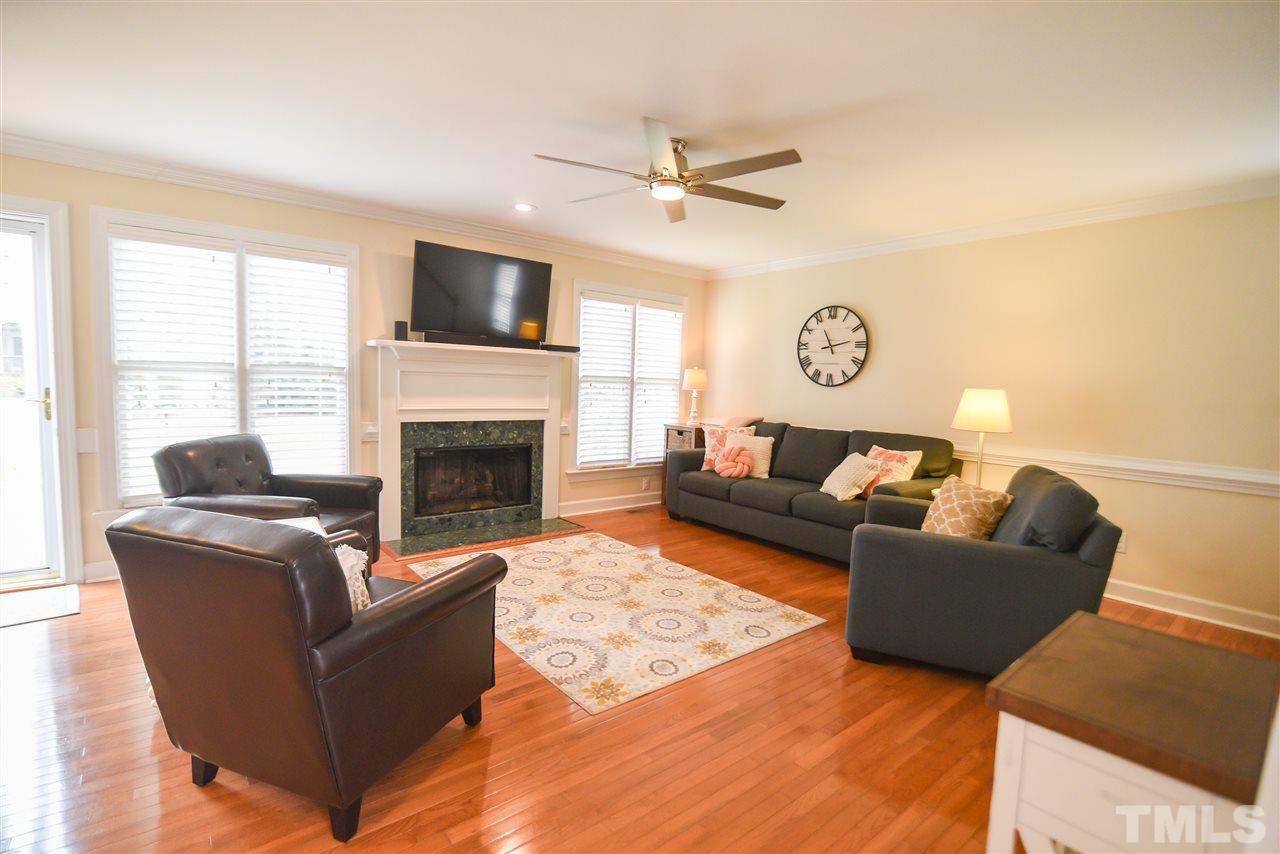 9200 Dawnshire Road Raleigh, NC 27615 - Photo 16 of 30 a living room with furniture a flat screen tv and a fireplace