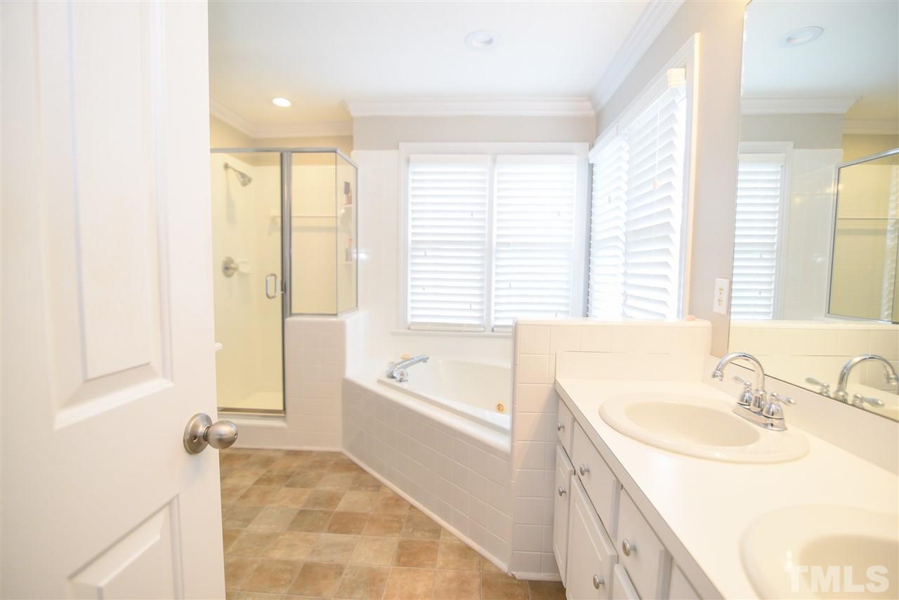 9200 Dawnshire Road Raleigh, NC 27615 - Photo 21 of 30 a bathroom with a tub sink and mirror