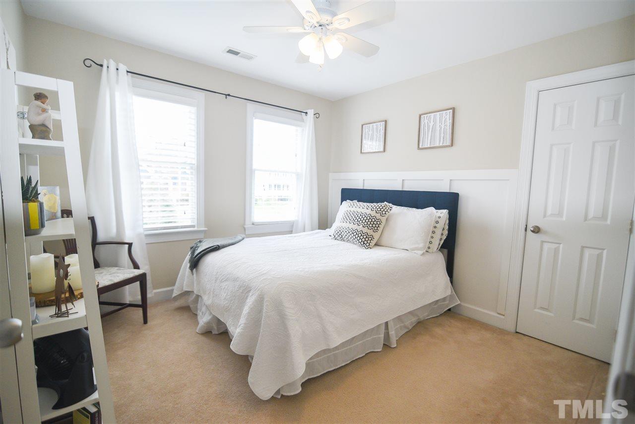 9200 Dawnshire Road Raleigh, NC 27615 - Photo 22 of 30 a bedroom with a bed and a chandelier