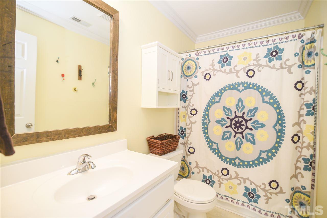 9200 Dawnshire Road Raleigh, NC 27615 - Photo 23 of 30 a bathroom with a sink and mirror with shower curtain