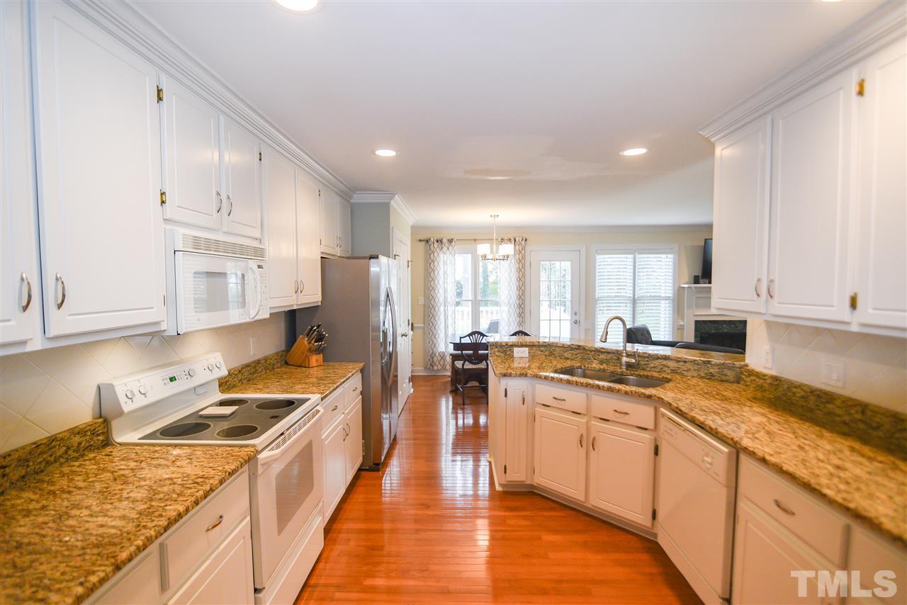 9200 Dawnshire Road Raleigh, NC 27615 - Photo 7 of 30 a kitchen with a stove sink and cabinets